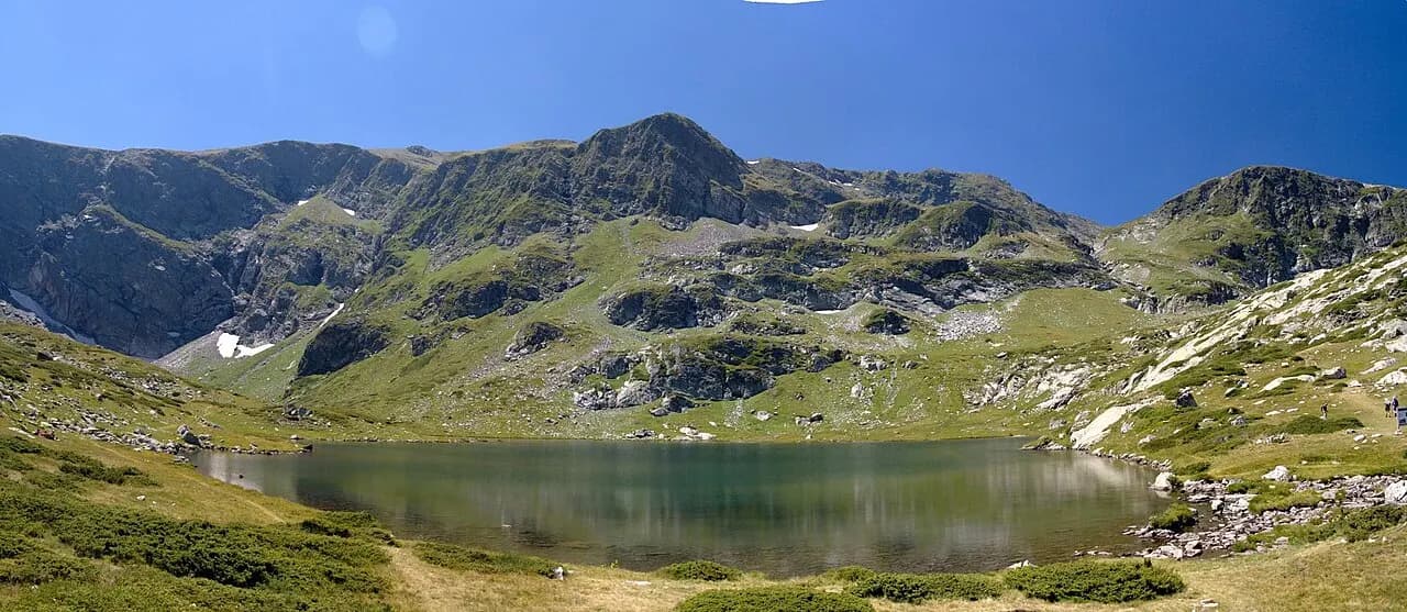 A glacial lake beneath green ridges in the Seven Rila Lakes cirque