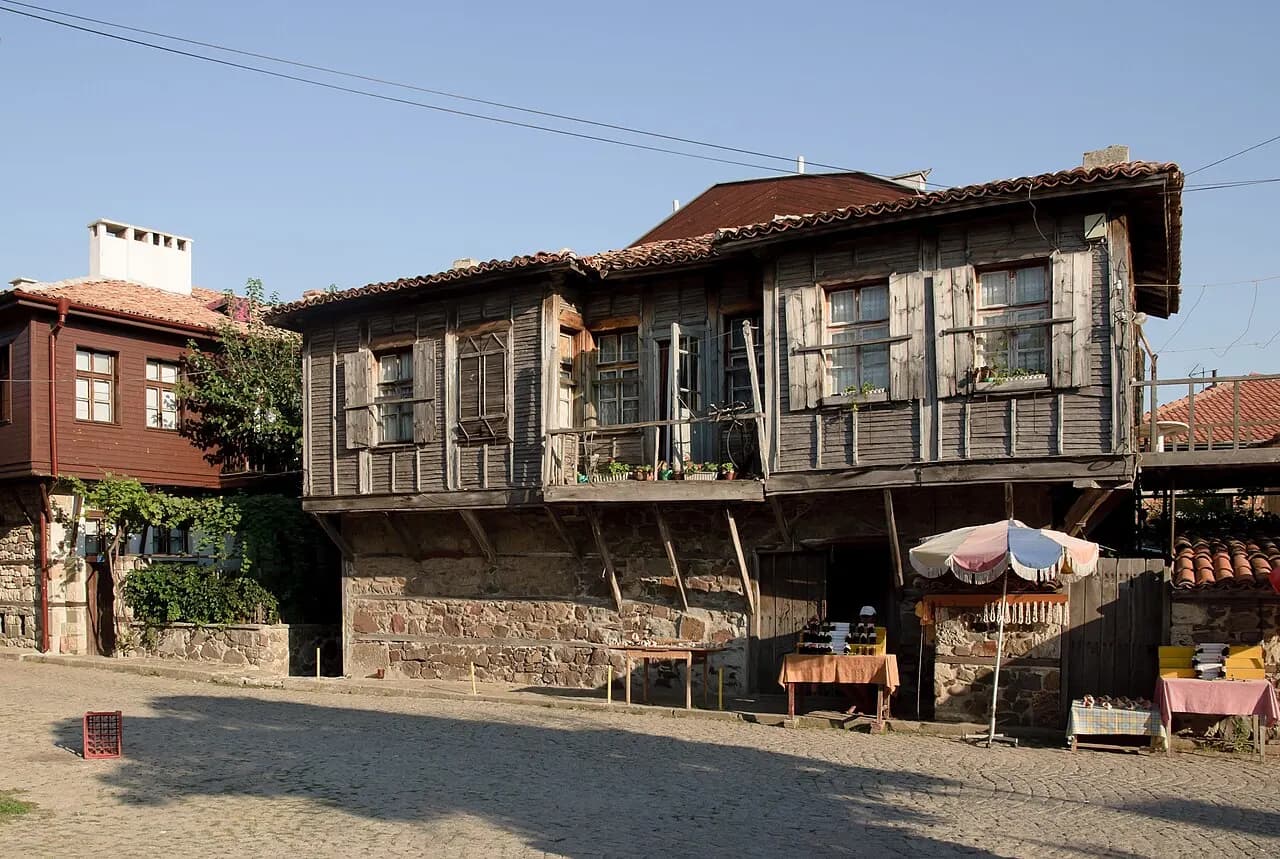 A traditional wooden house with a stone ground floor on a cobbled street in Sozopol