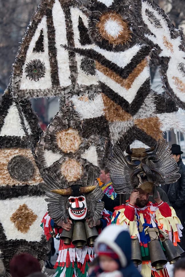 Kukeri performers wearing elaborate fur costumes and masks at Surva festival